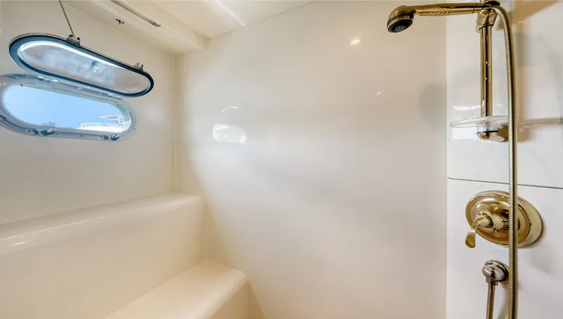 Slide: The Image of Luxurious 2007 Horizon 95 yacht bathroom with shower and porthole window. - 41