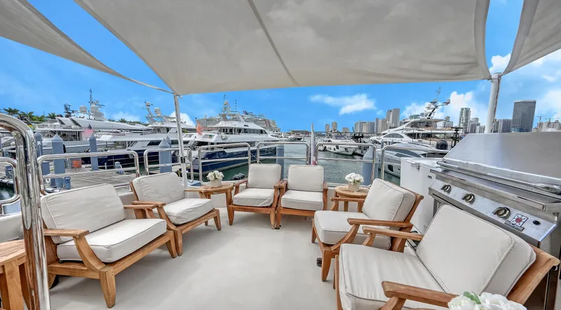 Slide: The Image of Luxurious Horizon 95 yacht deck with seating, marina view, and city skyline, 2007 model. - 47