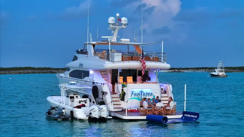 Slide: The Image of Luxurious 2007 Horizon 95 yacht anchored in serene blue waters at sunset. - 5