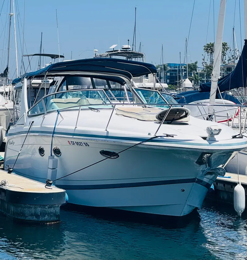 The Image of 2000 Chris-Craft 308 Express Cruiser docked at marina, sunny day, clear blue sky. - 0