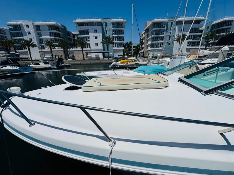 Slide: The Image of 2000 Chris-Craft 308 Express Cruiser docked at marina with modern buildings in background. - 10