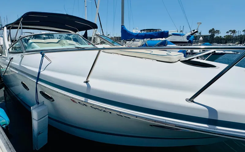 Slide: The Image of 2000 Chris-Craft 308 Express Cruiser docked at marina under clear blue sky. - 11