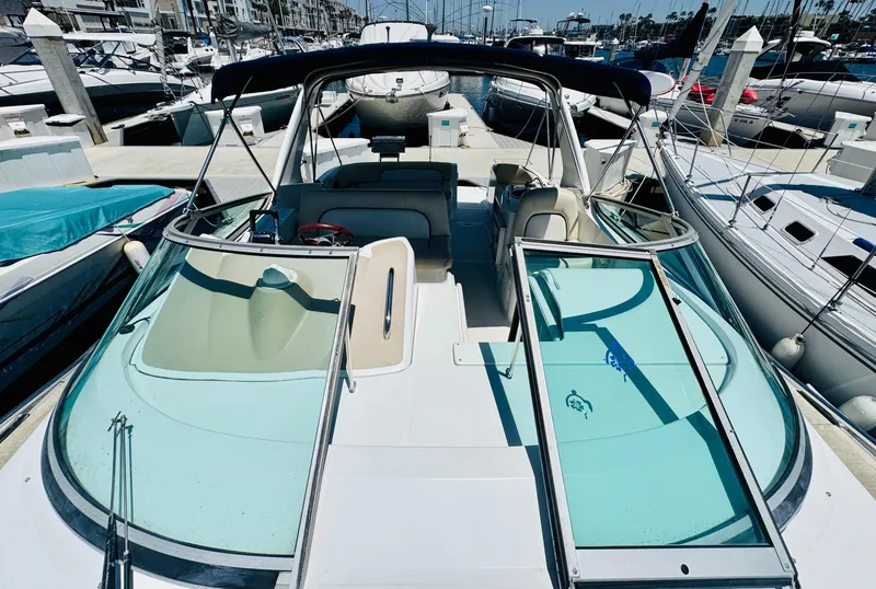 Slide: The Image of 2000 Chris-Craft 308 Express Cruiser docked at marina, showcasing sleek design and spacious deck. - 13