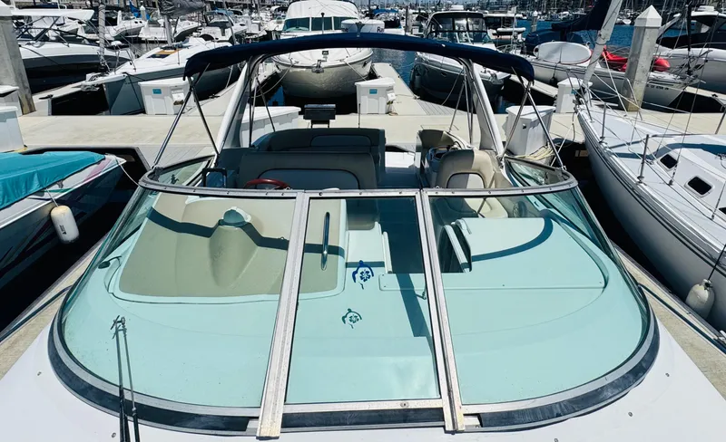 Slide: The Image of 2000 Chris-Craft 308 Express Cruiser docked at a marina, showcasing sleek design and spacious deck. - 14