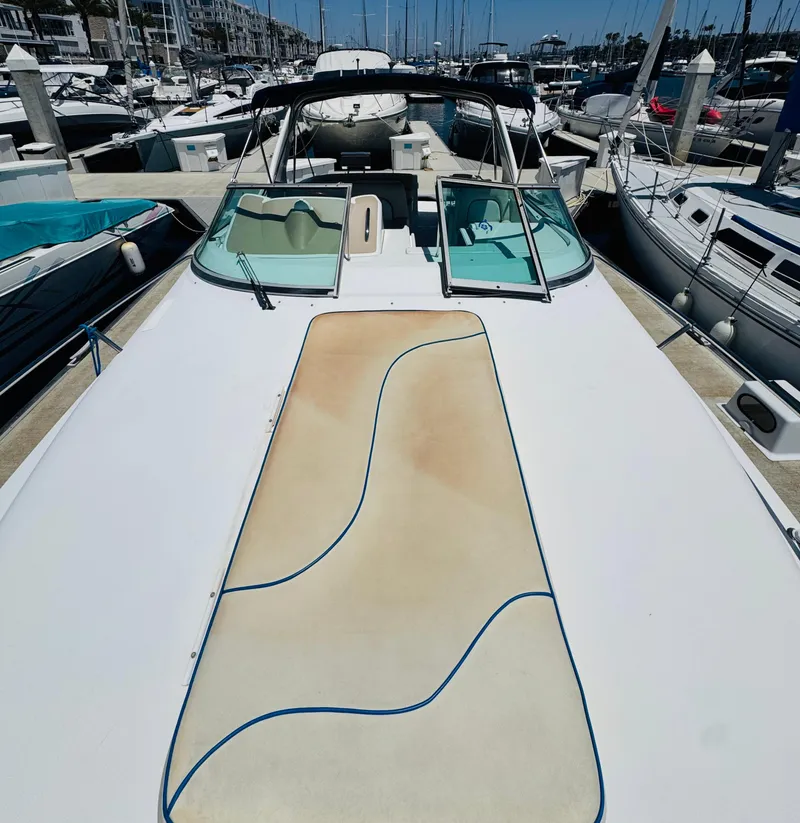 Slide: The Image of 2000 Chris-Craft 308 Express Cruiser docked at marina, showcasing spacious deck and sleek design. - 15