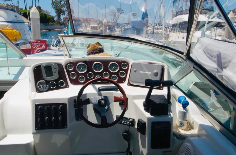 Slide: The Image of Cockpit of 2000 Chris-Craft 308 Express Cruiser with steering wheel and navigation instruments. - 21