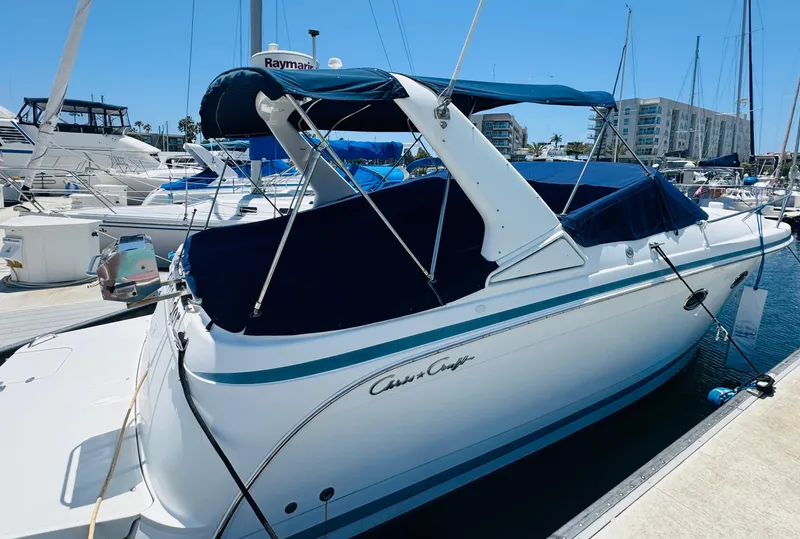 Slide: The Image of 2000 Chris-Craft 308 Express Cruiser docked at marina under clear blue sky. - 4