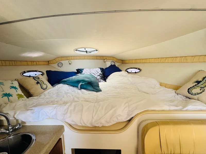 Slide: The Image of Cozy cabin interior of 2000 Chris-Craft 308 Express Cruiser with plush bedding and pillows. - 41