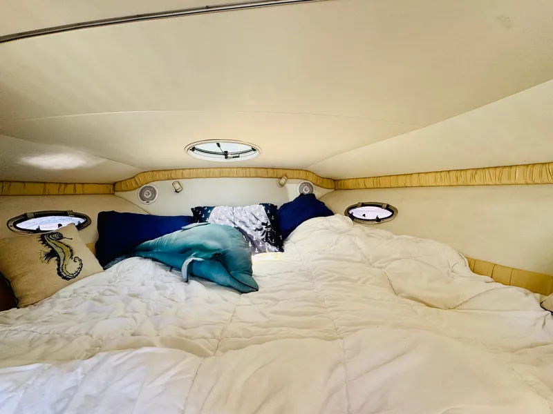 Slide: The Image of Cozy cabin interior of 2000 Chris-Craft 308 Express Cruiser with plush bedding and pillows. - 42