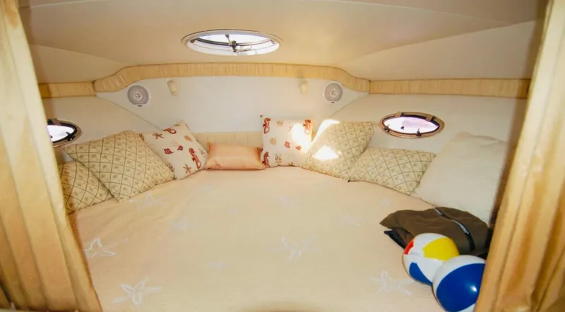 Slide: The Image of Cozy cabin interior of 2000 Chris-Craft 308 Express Cruiser with pillows and portholes. - 43