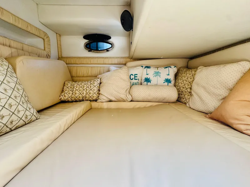 Slide: The Image of Cozy cabin interior of 2000 Chris-Craft 308 Express Cruiser with plush cushions and porthole. - 45