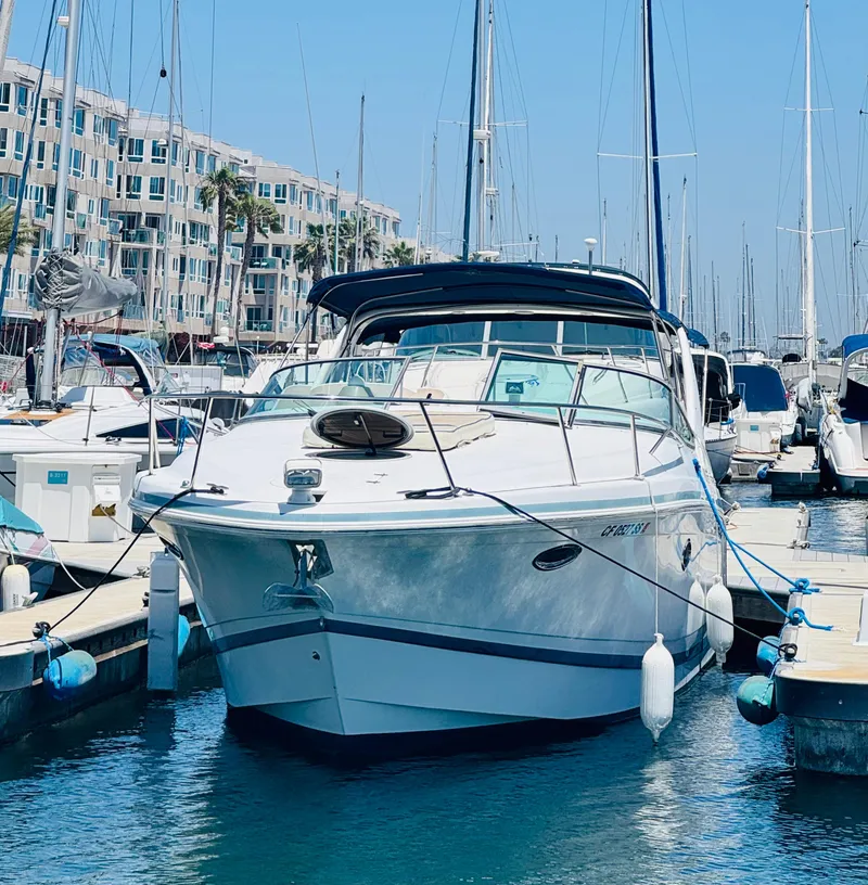 Slide: The Image of 2000 Chris-Craft 308 Express Cruiser docked at a marina with clear blue skies. - 6