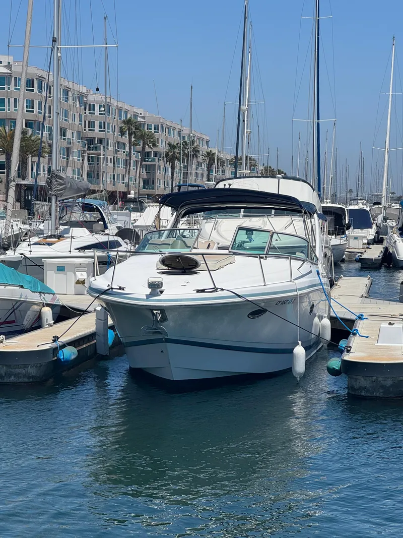 Slide: The Image of 2000 Chris-Craft 308 Express Cruiser docked in a marina, surrounded by other boats. - 7
