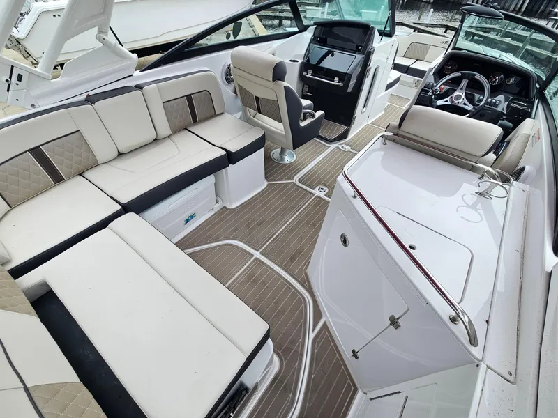 Slide: The Image of 2023 Monterey M-65 boat interior with luxurious seating and modern dashboard. - 10