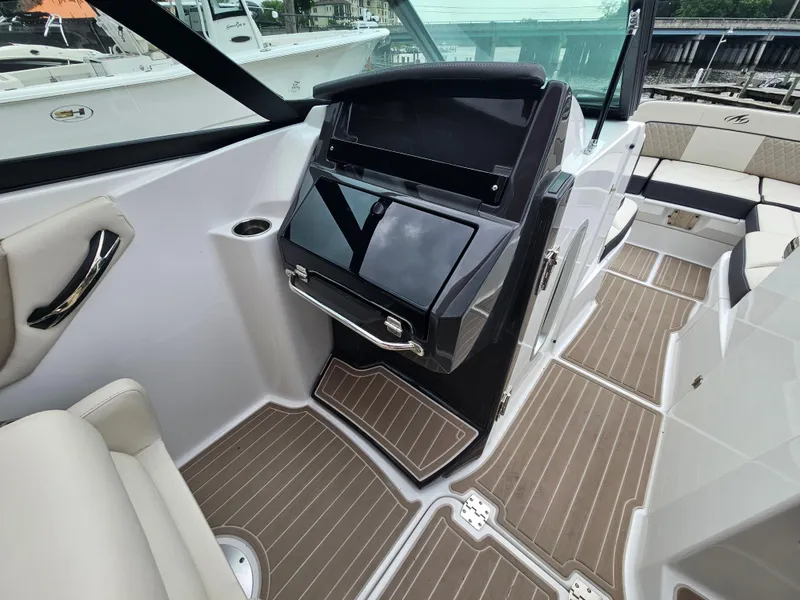 Slide: The Image of 2023 Monterey M-65 boat interior with sleek dashboard and modern seating. - 15
