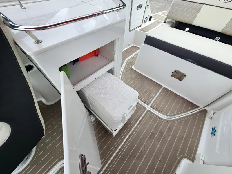Slide: The Image of 2023 Monterey M-65 boat interior with storage compartment and seating area. - 21