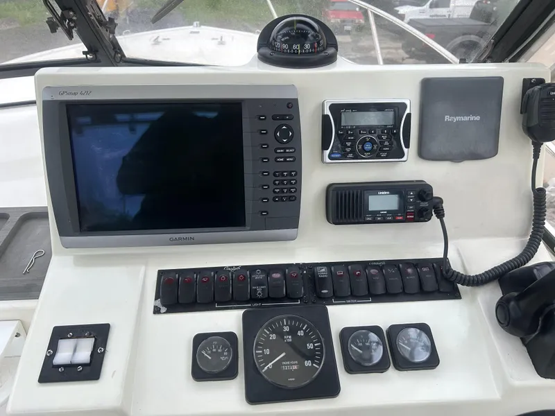 Slide: The Image of Control panel of a 1998 Carolina Classic 25 Express boat with navigation and communication equipment. - 13