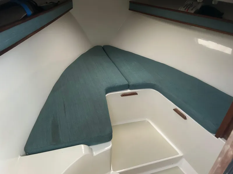 Slide: The Image of 1998 Carolina Classic 25 Express cabin interior with teal cushions. - 16