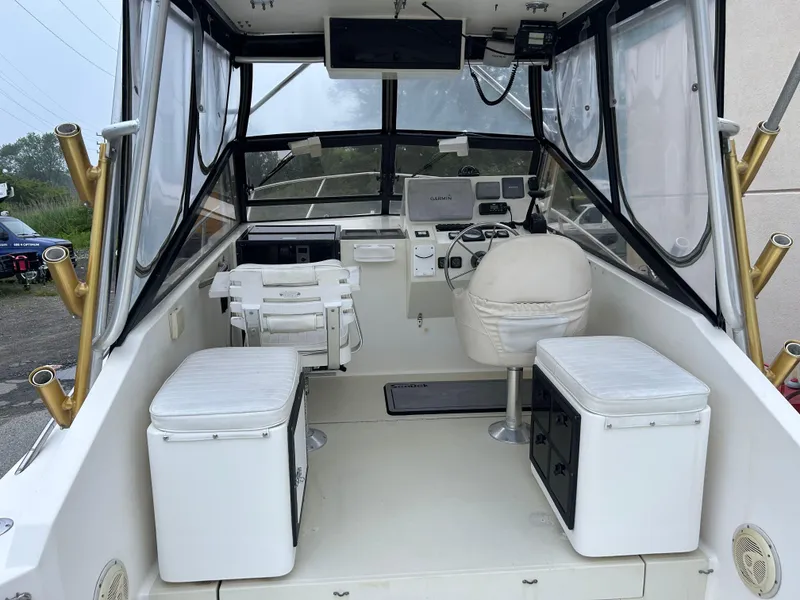 Slide: The Image of 1998 Carolina Classic 25 Express boat interior with seating and control panel. - 17