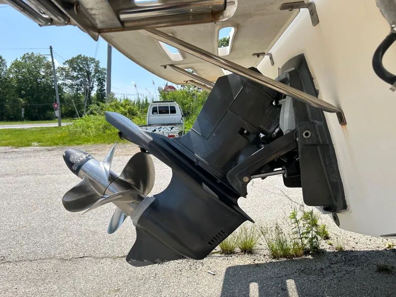 Slide: The Image of 1998 Carolina Classic 25 Express boat propeller and outboard motor detail. - 7