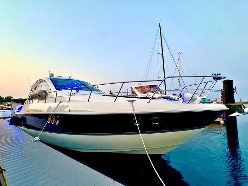 Slide: The Image of 2014 Cruisers Yachts 540 SC docked at sunset, showcasing sleek design and luxury features. - 1