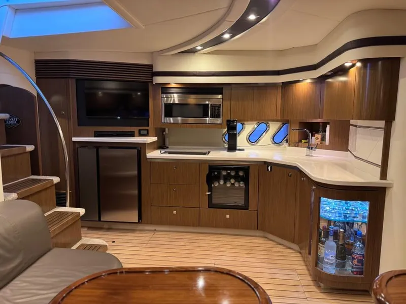 Slide: The Image of Luxurious 2014 Cruisers Yachts 540 SC interior with modern kitchen and elegant wood finishes. - 9