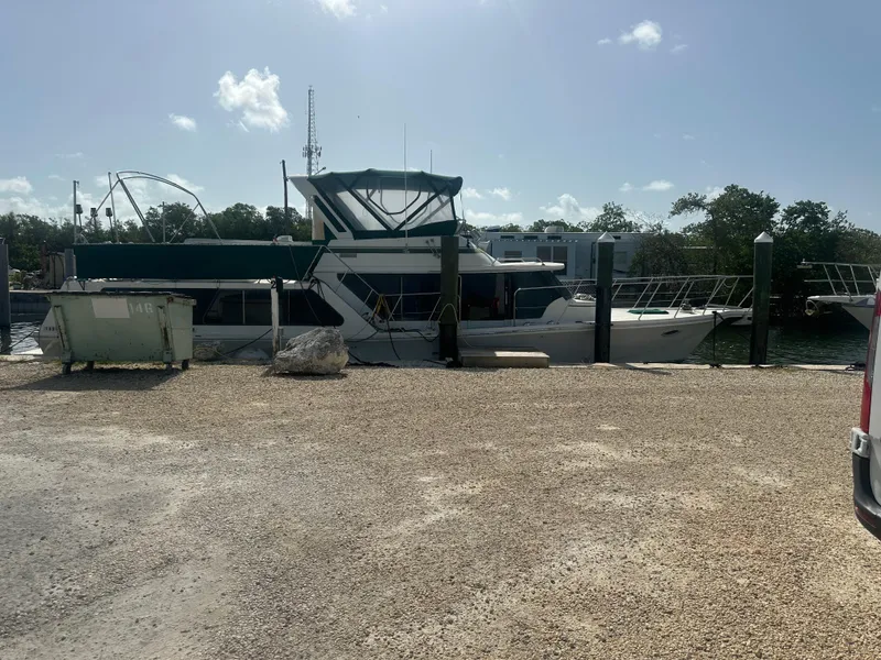 Slide: The Image of 1989 Bluewater 51' Coastal Cruiser docked at a marina under a clear sky. - 1