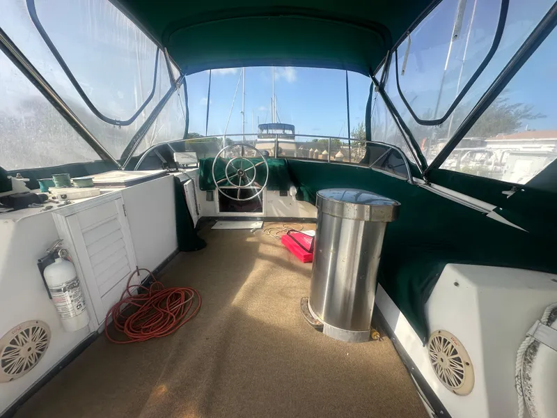 Slide: The Image of 1989 Bluewater 51' Coastal Cruiser interior with green canopy and nautical equipment. - 10