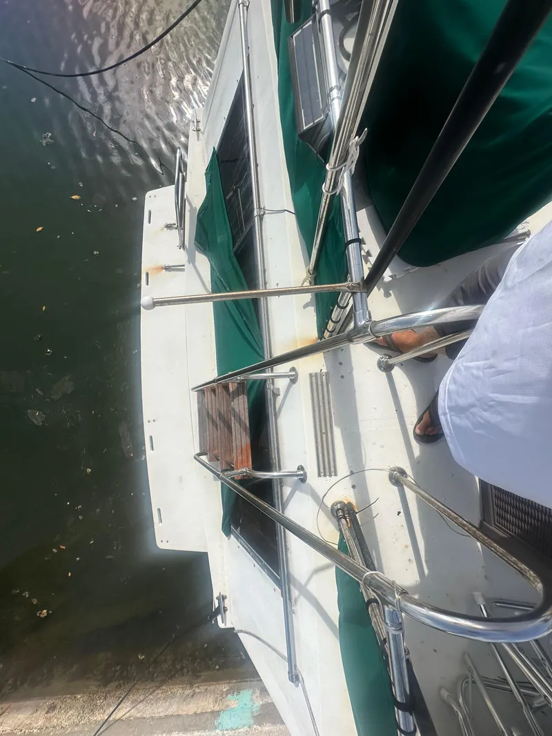 Slide: The Image of 1989 Bluewater 51' Coastal Cruiser yacht, top view, docked with green accents. - 12