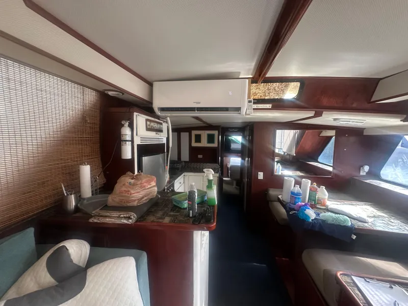 Slide: The Image of Interior of 1989 Bluewater 51' Coastal Cruiser, featuring kitchen and seating area. - 16