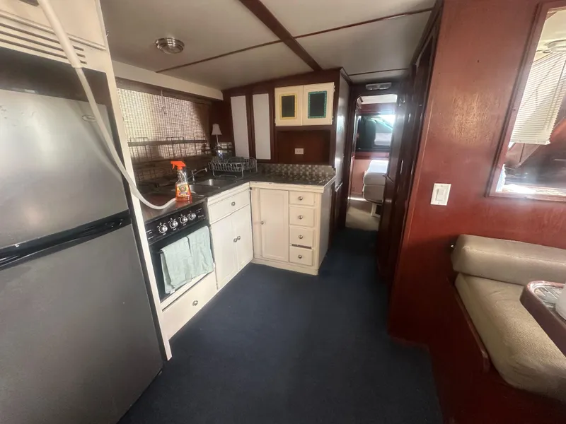 Slide: The Image of Interior of 1989 Bluewater 51' Coastal Cruiser with kitchen and seating area. - 18