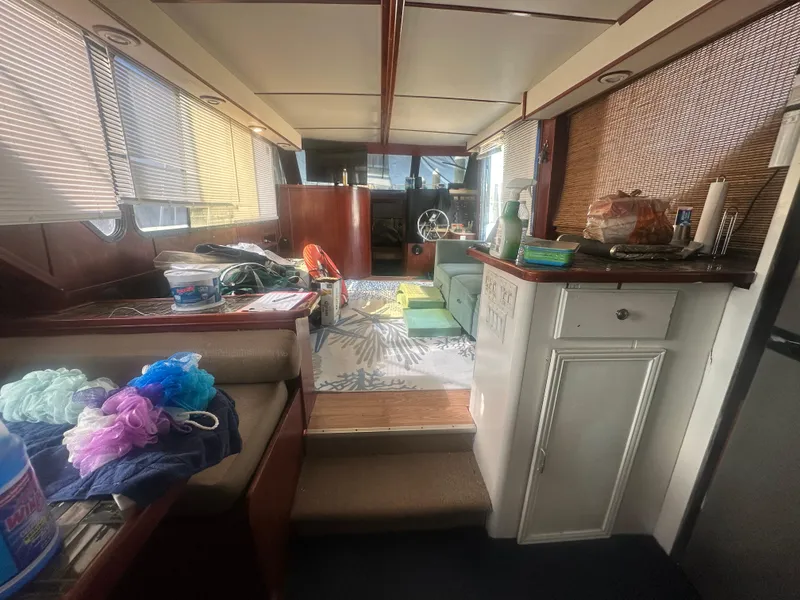 Slide: The Image of Interior of 1989 Bluewater 51' Coastal Cruiser with cozy seating and nautical decor. - 19