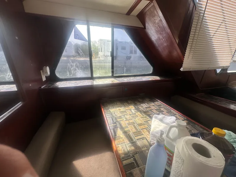 Slide: The Image of Interior of 1989 Bluewater 51' Coastal Cruiser with table and cleaning supplies. - 21