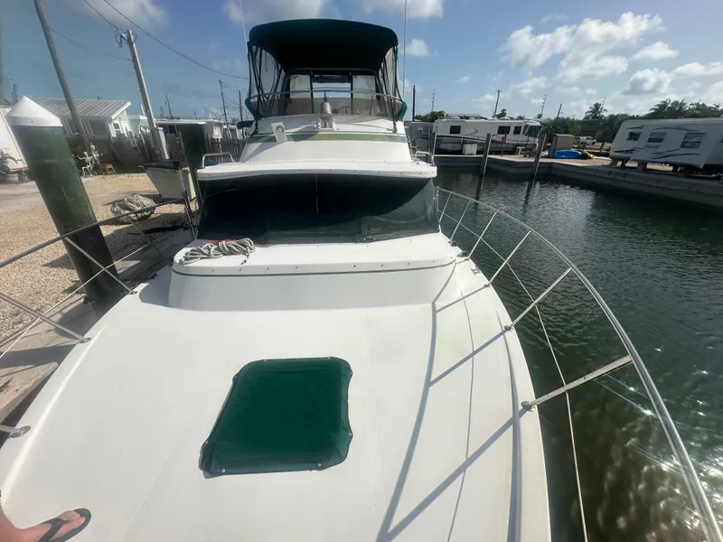 Slide: The Image of 1989 Bluewater 51' Coastal Cruiser docked at marina under clear sky. - 3