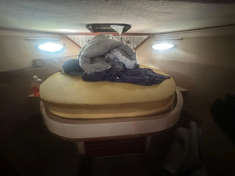 Slide: The Image of Interior cabin of 1989 Bluewater 51' Coastal Cruiser with bed and portholes. - 30