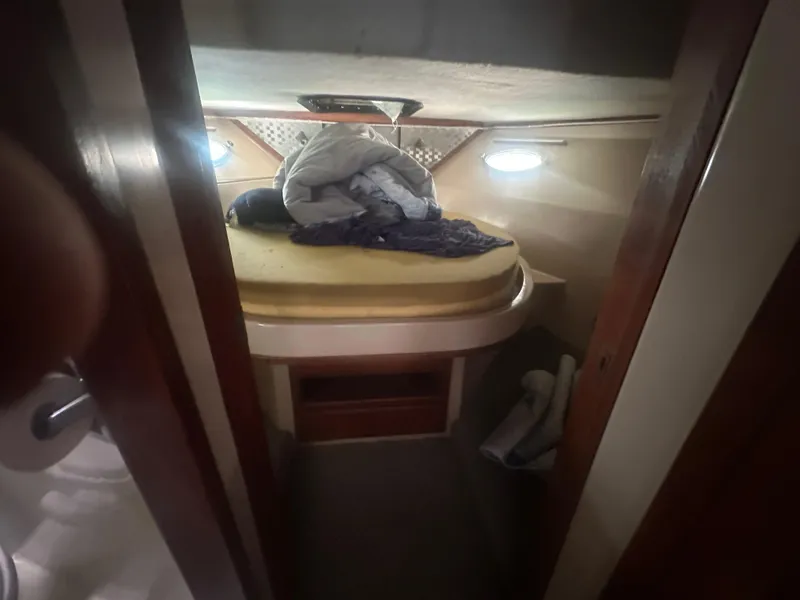 Slide: The Image of Cozy cabin interior of 1989 Bluewater 51' Coastal Cruiser with bed and storage. - 31