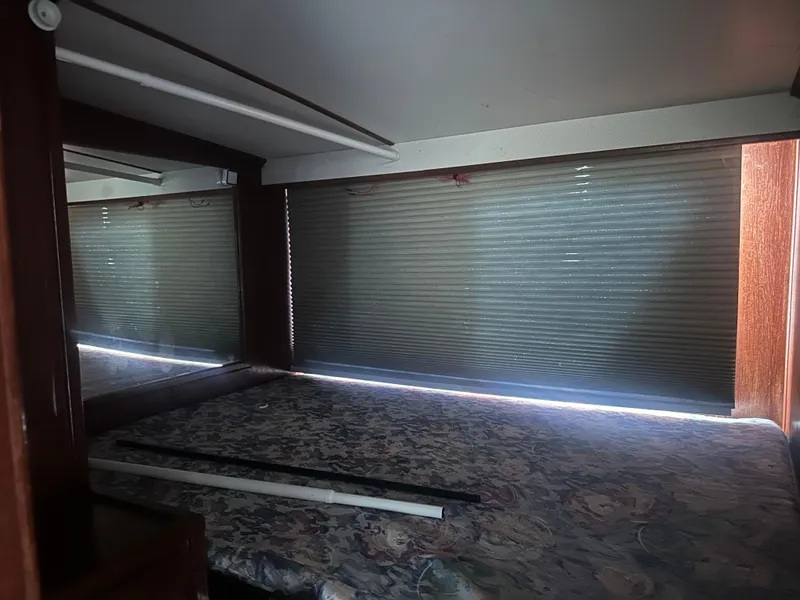 Slide: The Image of Interior of 1989 Bluewater 51' Coastal Cruiser with bed and window blinds. - 33