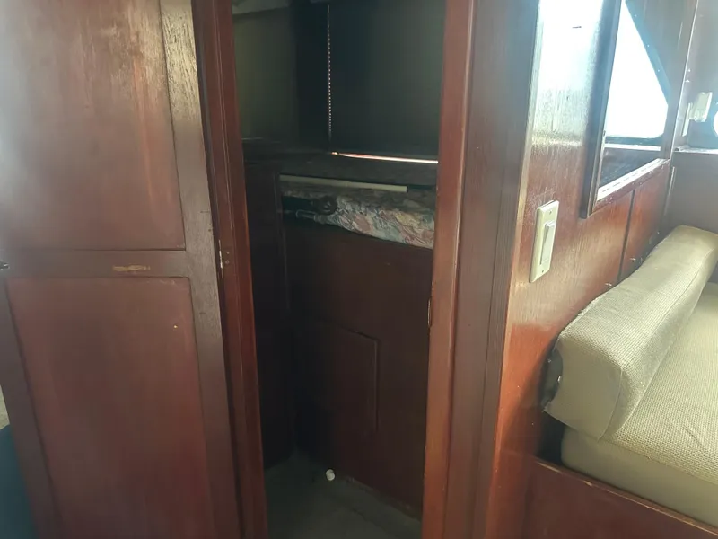 Slide: The Image of Interior view of 1989 Bluewater 51' Coastal Cruiser, featuring wooden cabinetry and seating area. - 34