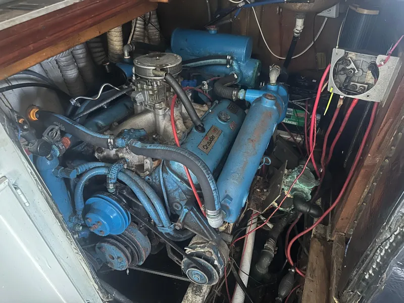 Slide: The Image of Engine compartment of a 1989 Bluewater 51' Coastal Cruiser, showcasing mechanical components and wiring. - 35