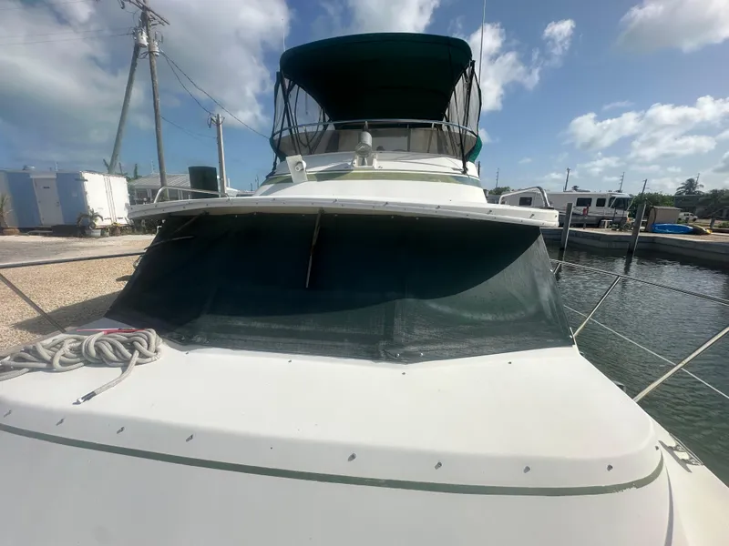 Slide: The Image of 1989 Bluewater 51' Coastal Cruiser docked under a clear blue sky. - 6