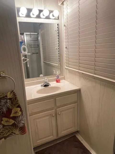 Slide: The Image of Small bathroom in a 2000 Funtime 16x72 houseboat with sink, mirror, and blinds. - 10