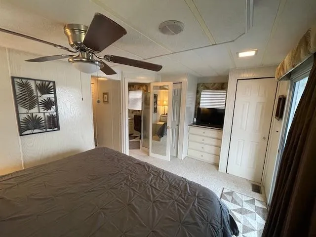 Slide: The Image of Cozy bedroom in 2000 Funtime 16x72 houseboat with ceiling fan and TV. - 14