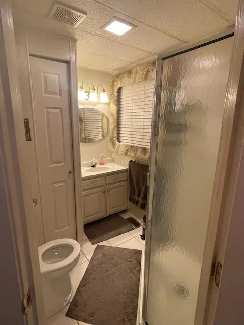 Slide: The Image of Bathroom interior of a 2000 Funtime 16x72 houseboat with shower and vanity. - 15