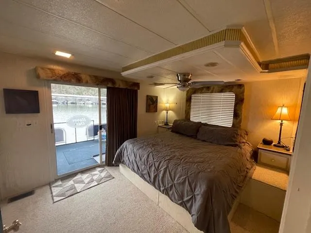 Slide: The Image of Cozy bedroom in 2000 Funtime 16x72 houseboat with lake view and modern decor. - 16