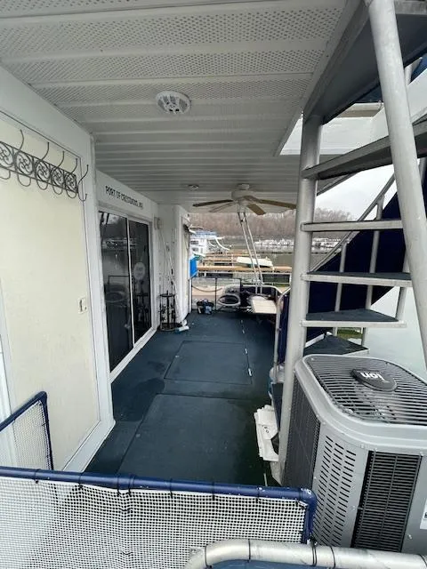 Slide: The Image of Houseboat deck with spiral staircase, ceiling fan, and outdoor seating. Funtime 16x72, 2000 model. - 17