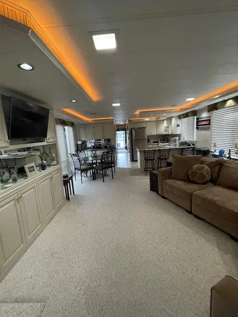 Slide: The Image of Spacious interior of 2000 Funtime 16x72 houseboat with modern kitchen and cozy seating area. - 4