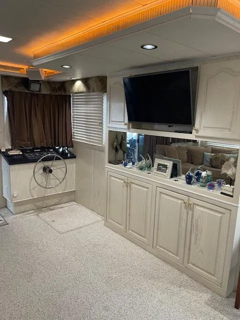 Slide: The Image of Interior of a 2000 Funtime 16x72 houseboat with modern decor and entertainment setup. - 6