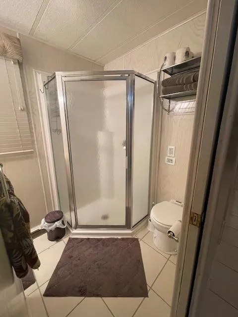 Slide: The Image of Small bathroom in a 2000 Funtime 16x72 houseboat with shower and toilet. - 9