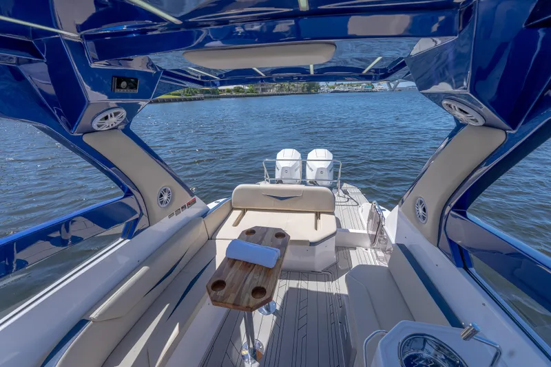 Slide: The Image of 2025 Hanover 305 Outboard boat interior with seating, table, and water view. - 13