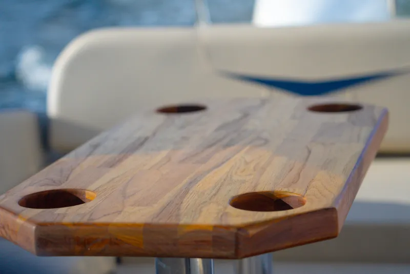 Slide: The Image of Wooden table with cup holders on a 2025 Hanover 305 Outboard boat. - 14